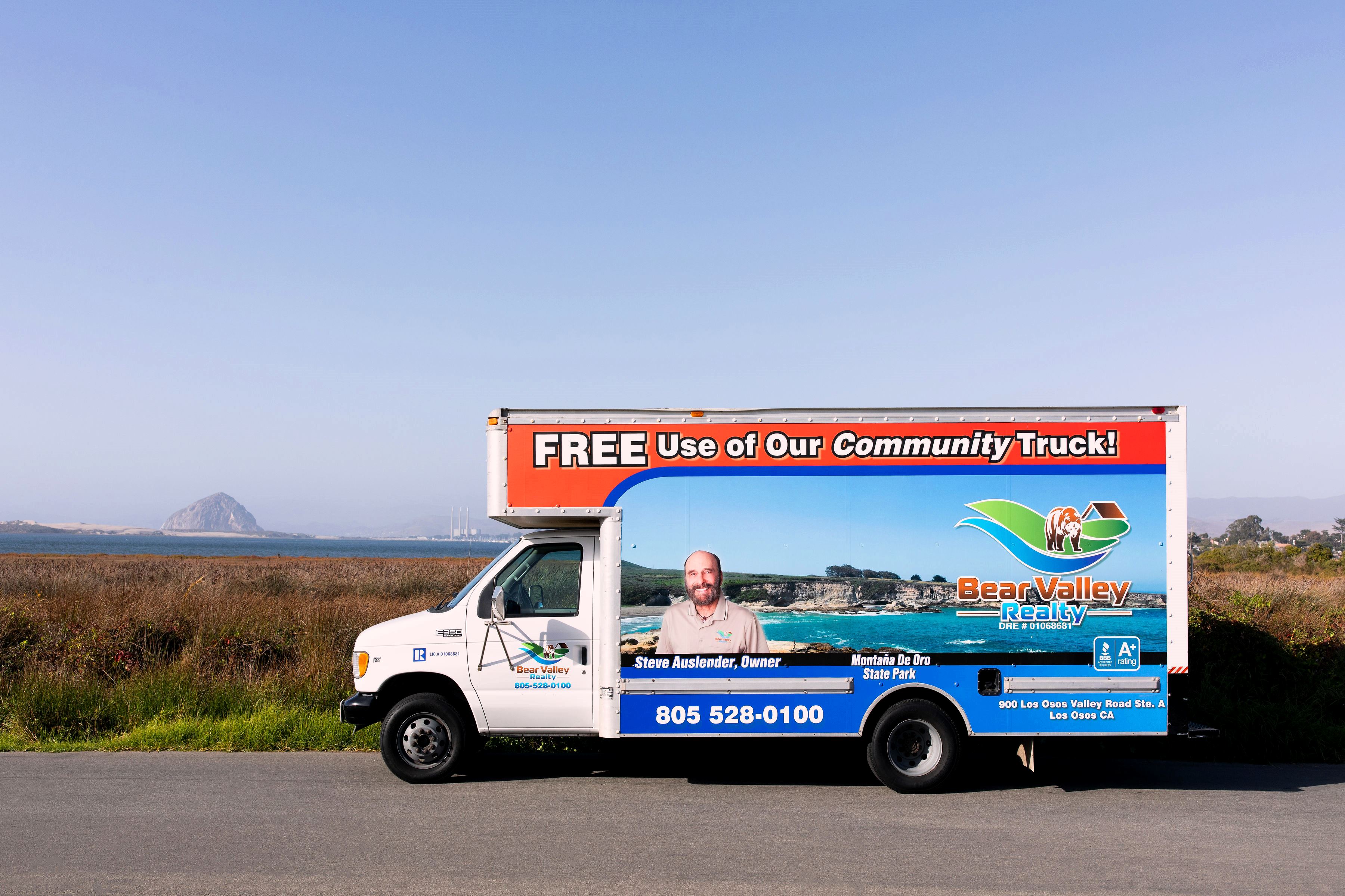 The Bear Valley Realty community truck parked in front of Morro Rock